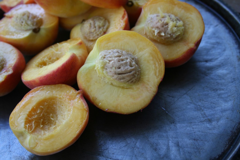 Fresh peaches halved for grilling